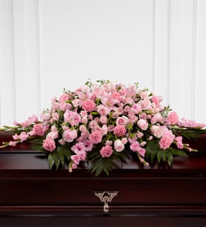 Pink floral casket spray with roses and carnations