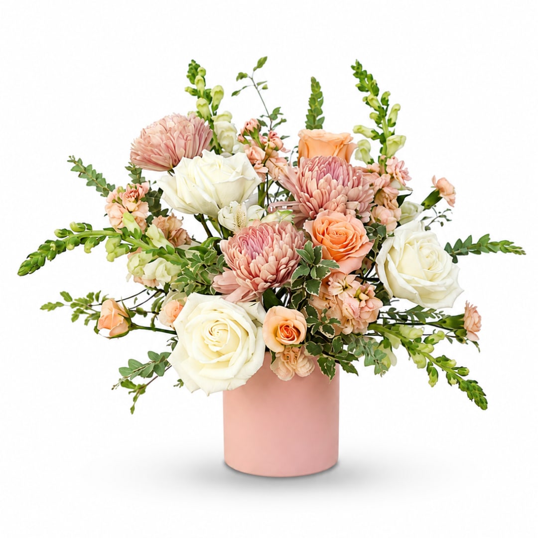 Pink and white floral arrangement in a blush vase