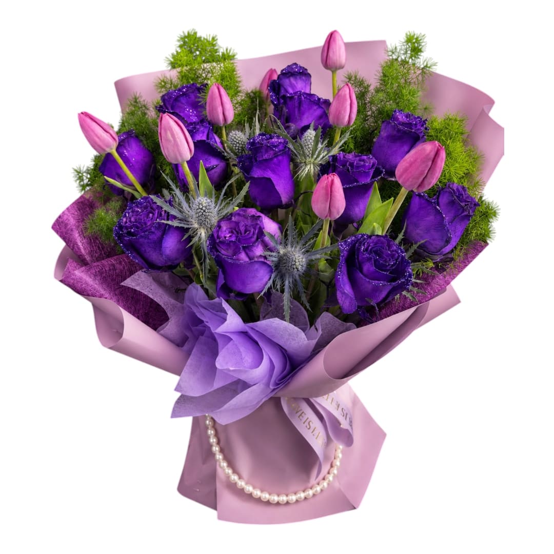 Purple roses and pink tulips in lavender wrapping with a pearl necklace