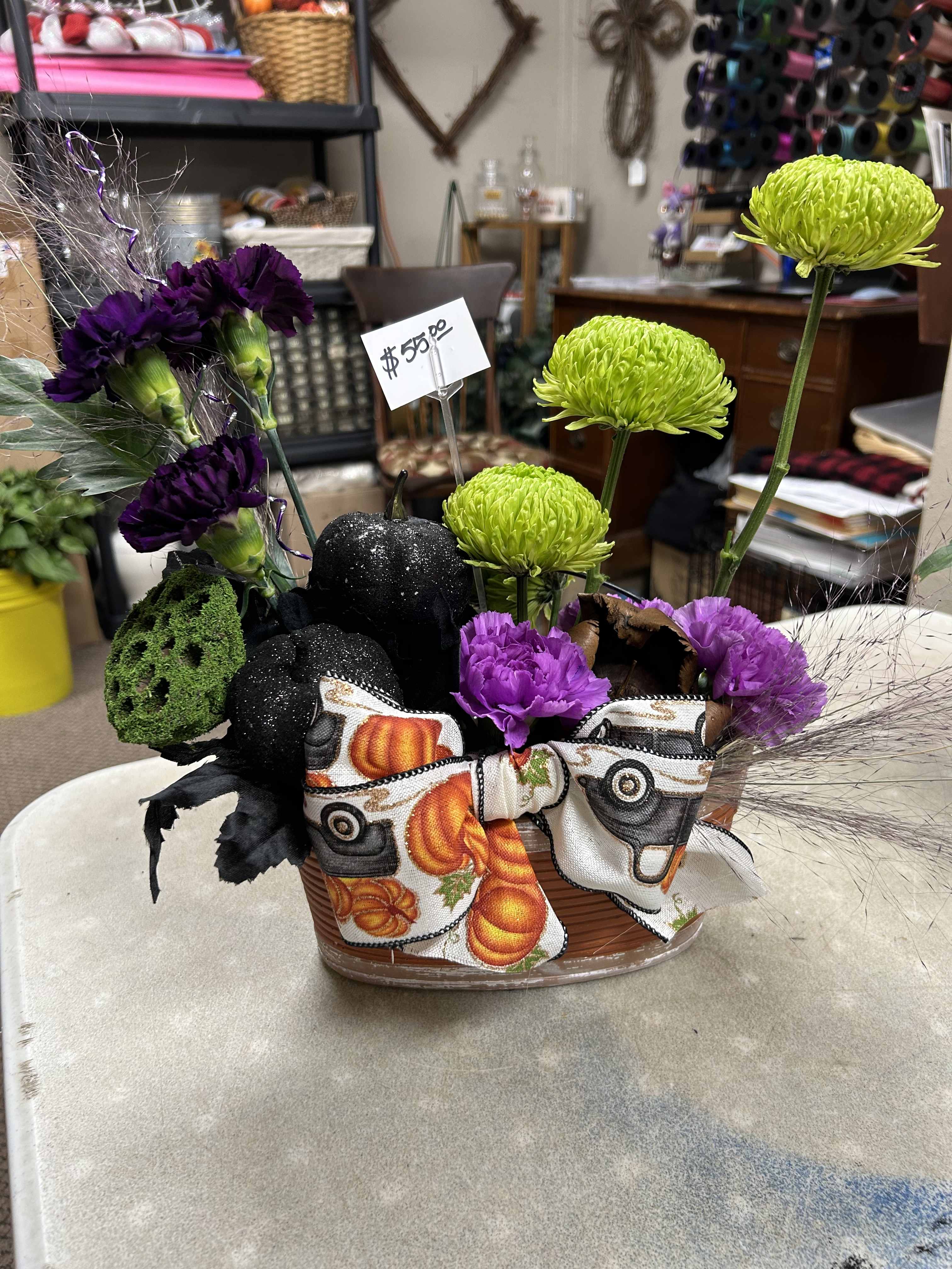Halloween floral basket with purple carnations and green chrysanthemums