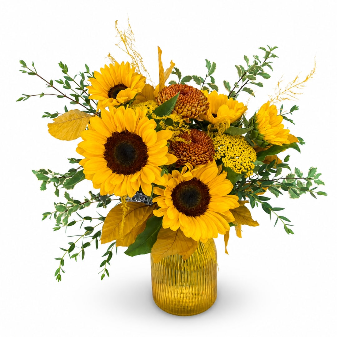 Sunflower arrangement in a ribbed yellow glass vase