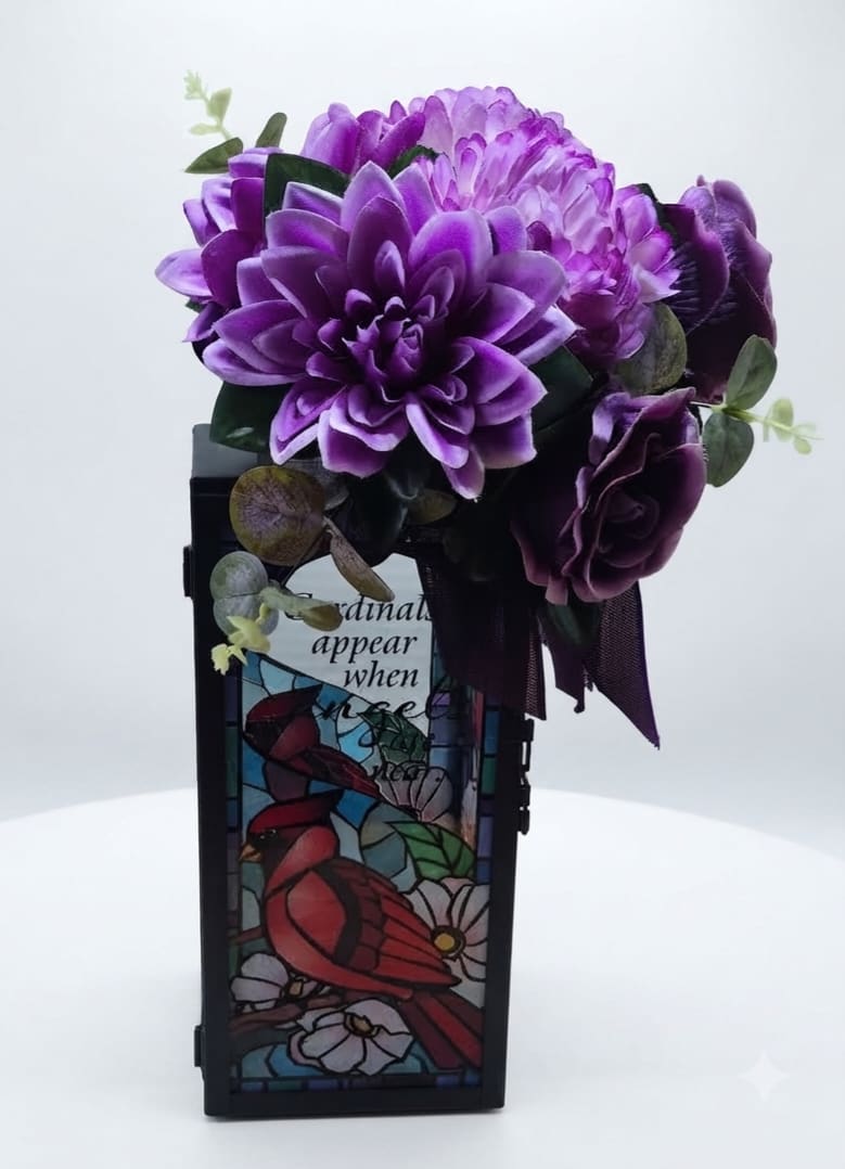 Purple floral arrangement in a stained-glass style vase