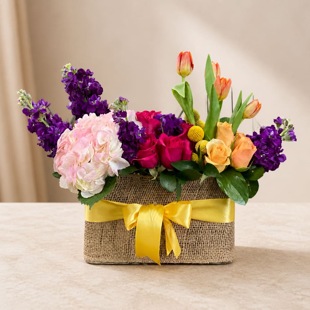 Mixed bouquet in a burlap box with a yellow ribbon