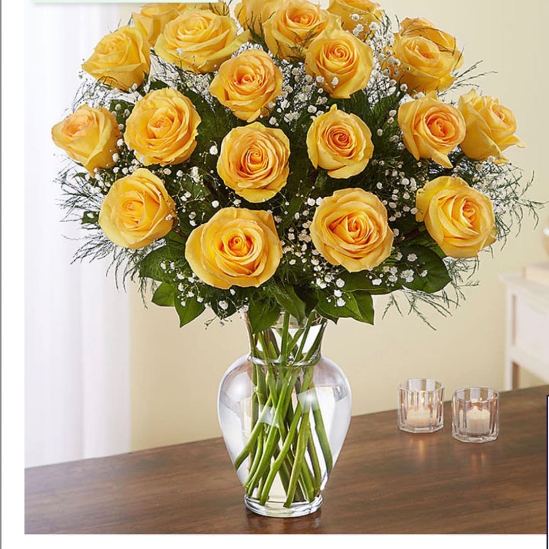 Yellow roses arranged in a clear glass vase
