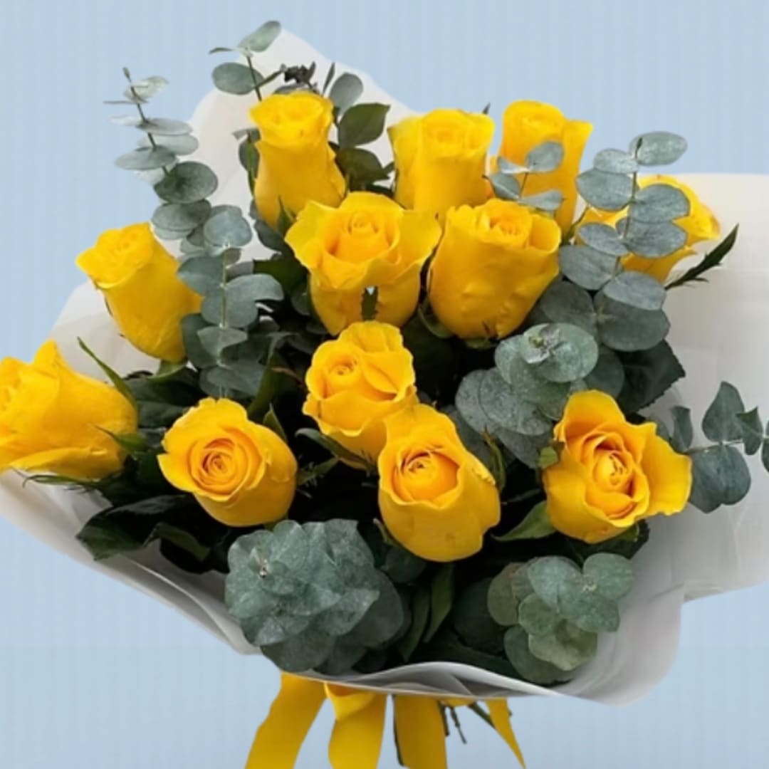 Bouquet of yellow roses with eucalyptus in white wrap