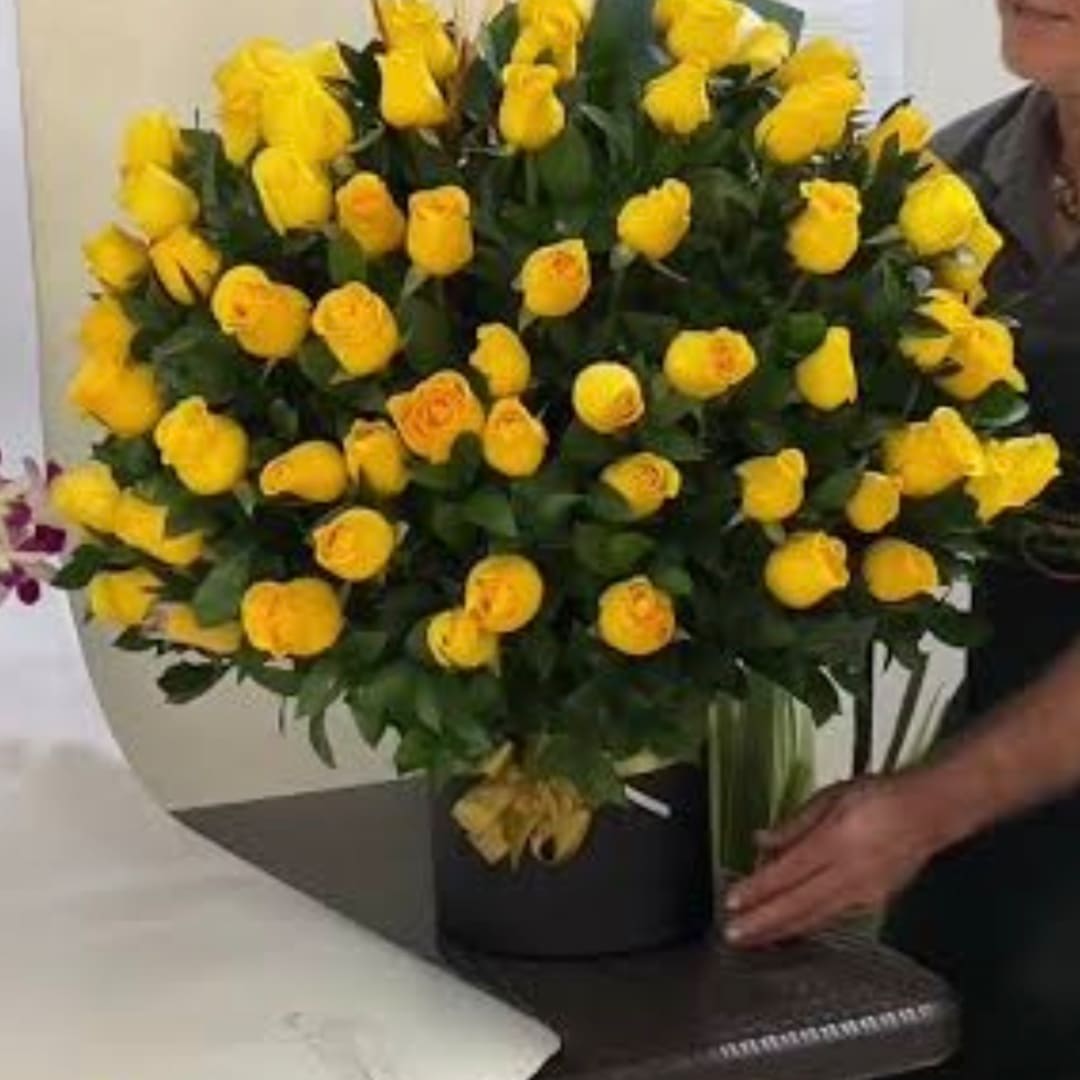 Large bouquet of yellow roses in a black box vase