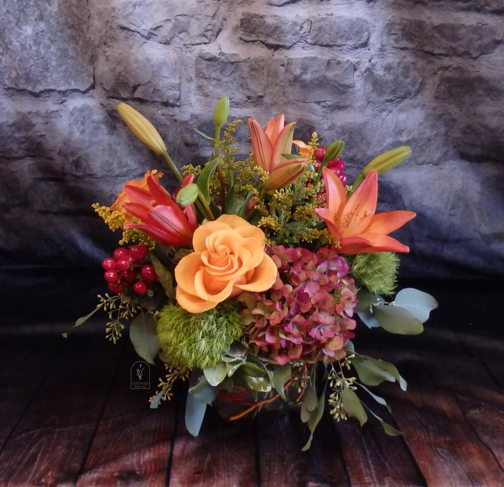 Pumpkin Spice - "Pumpkin Spice" is a cozy autumn-inspired arrangement featuring vibrant orange lilies, golden roses, hydrangea, and seasonal accents of berries and greenery. Bursting with rich fall colors, this design brings warmth and seasonal charm to any space in Danville, CA.