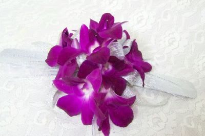 Purple orchid bouquet with a white ribbon