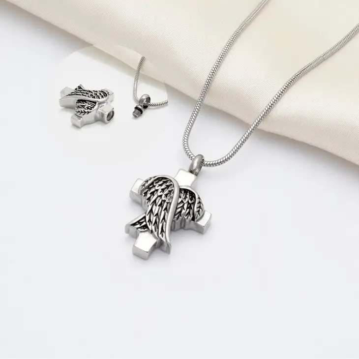 Angel Wings Cross Sympathy Gift Memorial Ash Holder - Always keep your loved ones close to your heart with our stainless steel memorial necklace keepsake. The memorial necklace is designed with a hidden compartment to store small amounts of ashes to always be able to have your loved ones close to you. Ask about personalization, extra fee would apply.  Note: The Memorial necklace can only hold a small amount of ashes.