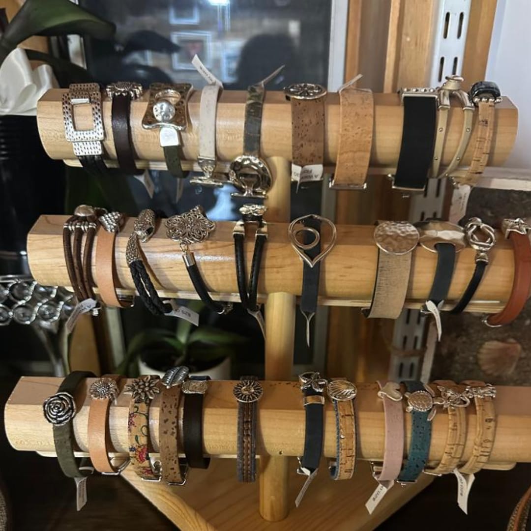Display rack of assorted wristwatches on wooden bars