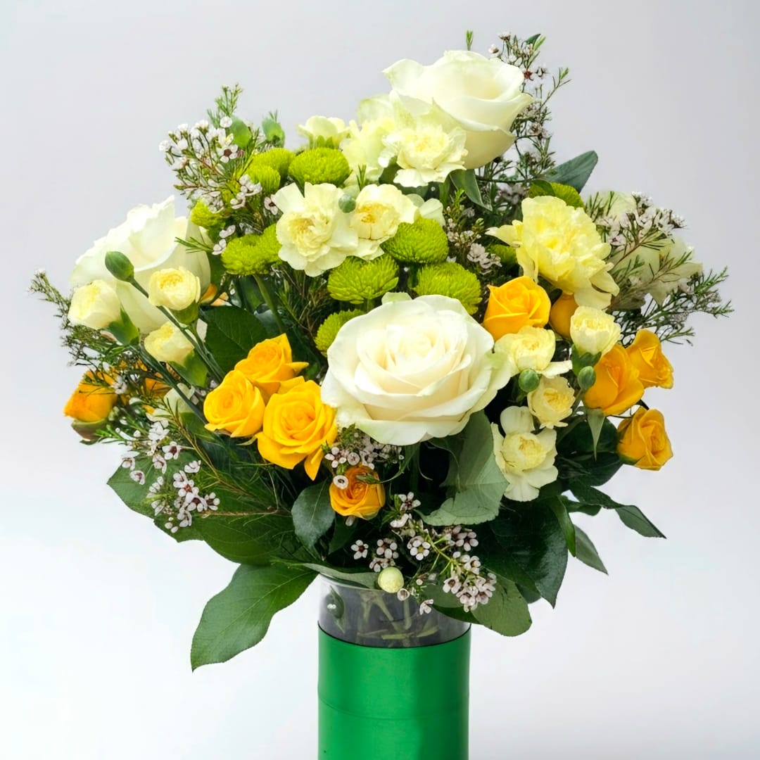 Bouquet of white and yellow roses with green button mums in a vase