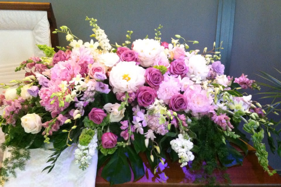 Large pink and white floral arrangement with roses and peonies