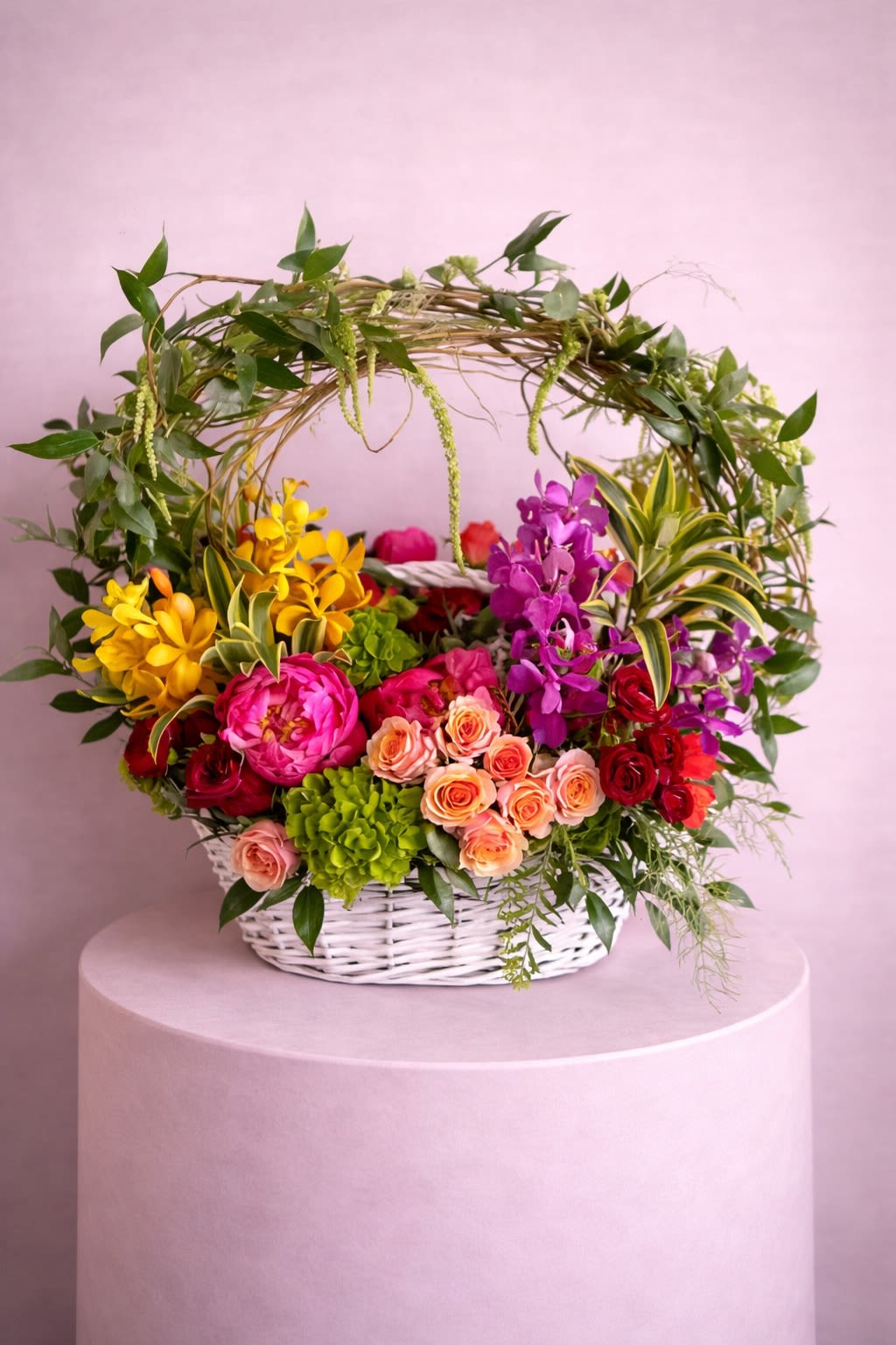Colorful flower basket with roses and orchids in a white wicker basket
