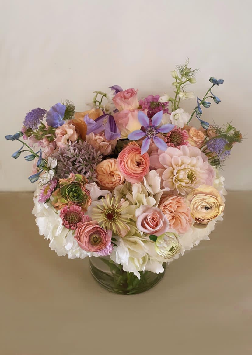 Fall wild - Gorgeous colors of fall in this lovely arrangment created with a touch of natural, wild garden in colors of gold, lavender and warm blush. Arranged in a 6" by 6" clear cylinder vase. Choose Deluxe or premium for a fuller arrangement with more stems.