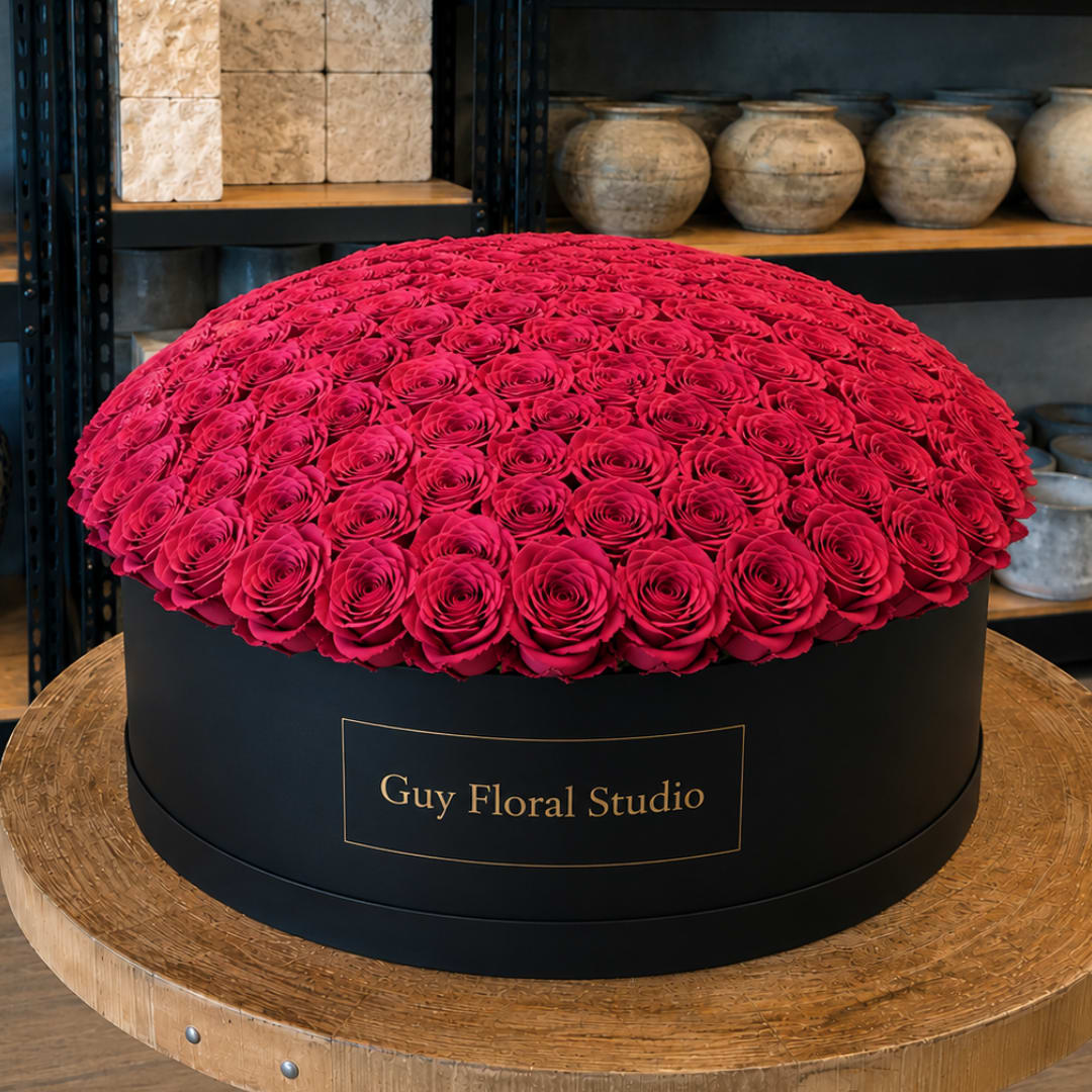 Large round box filled with red roses