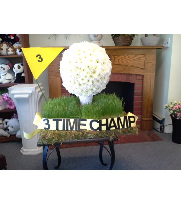 White chrysanthemum topiary with a "3 TIME CHAMP" ribbon