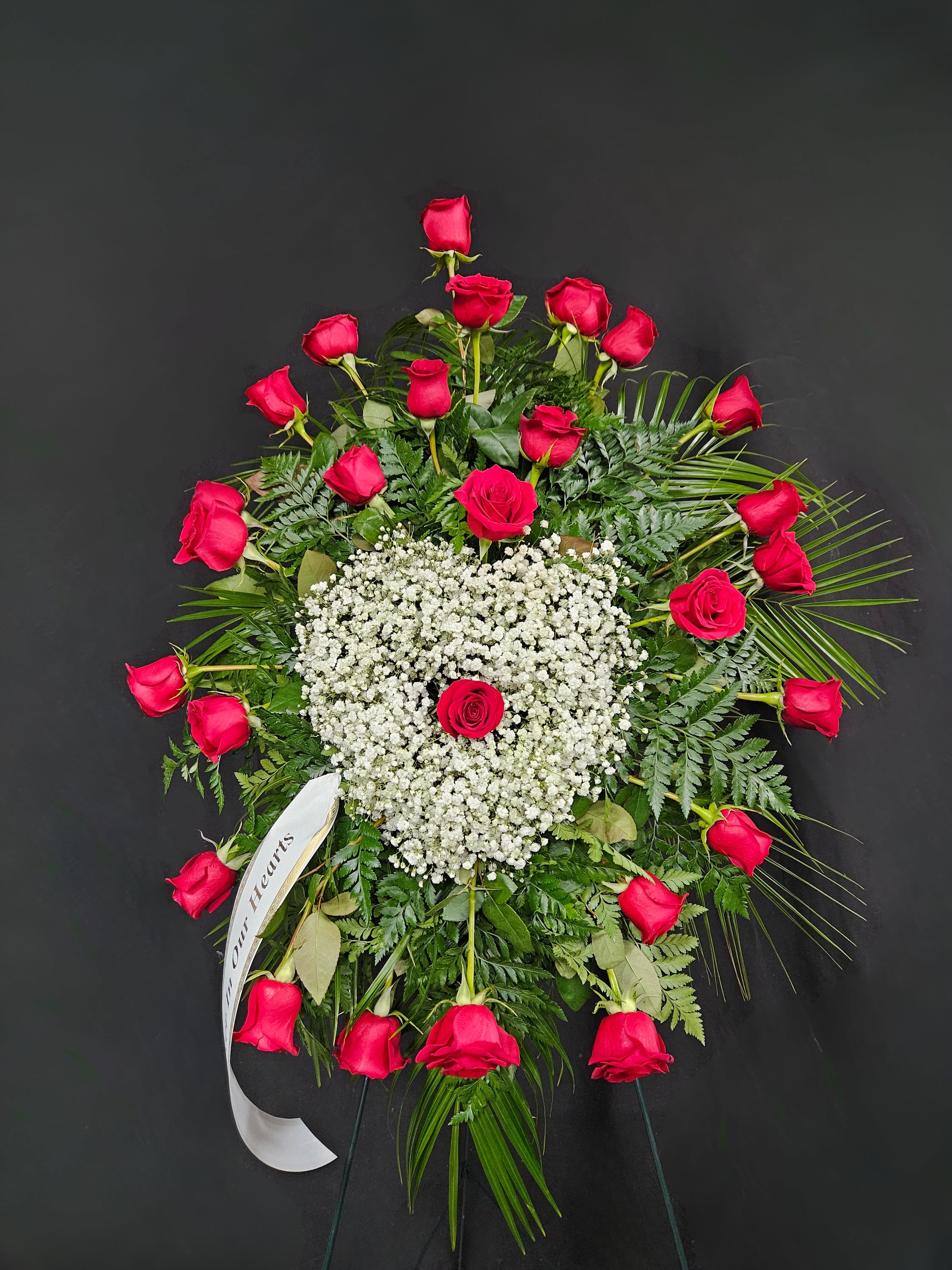 Red Rose Standing Spray with Baby's Breath Heart - Showing that even though they are gone, they will always be in your heart, this beautiful arrangement combines red roses with a heart-shaped burst of white baby's breath. Arrangement is mounted on a 4.5ft standing easel for prominent display at funeral services.