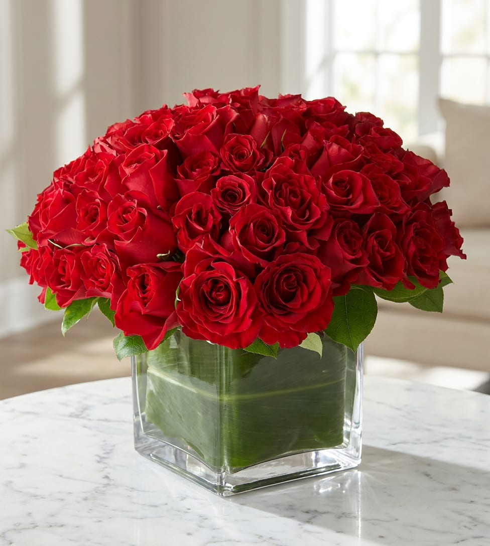 Red rose bouquet in a clear square glass vase