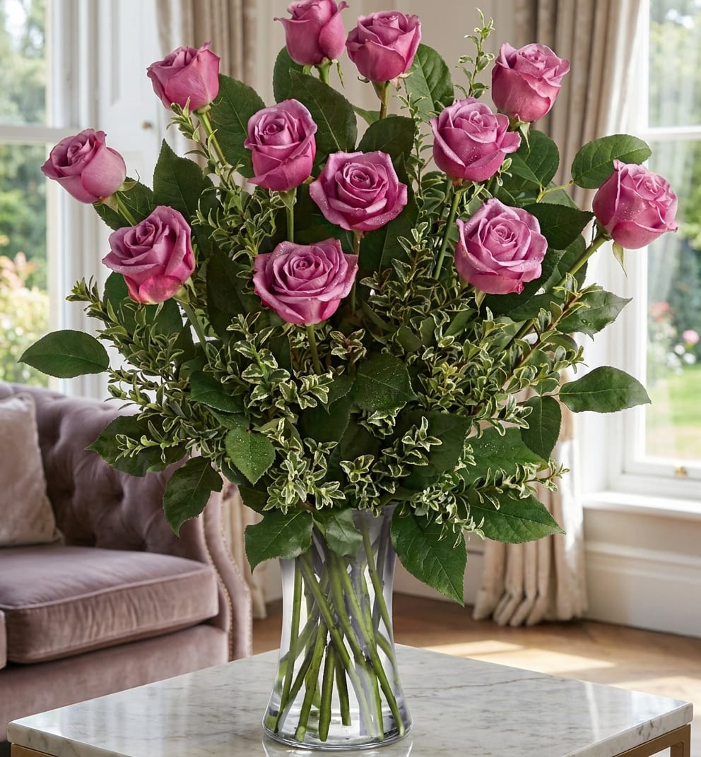 Pink roses arranged in a clear glass vase