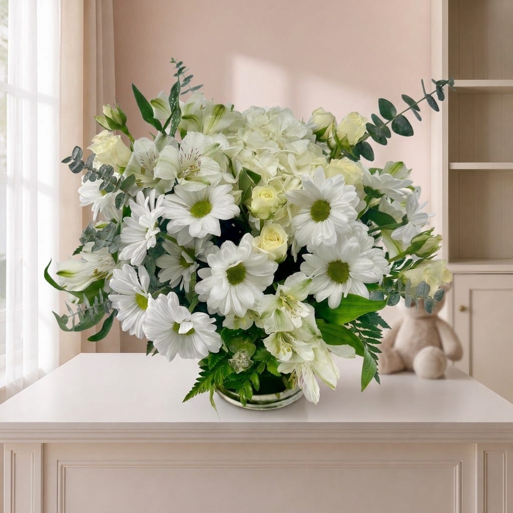 White daisy and rose bouquet in a low glass vase