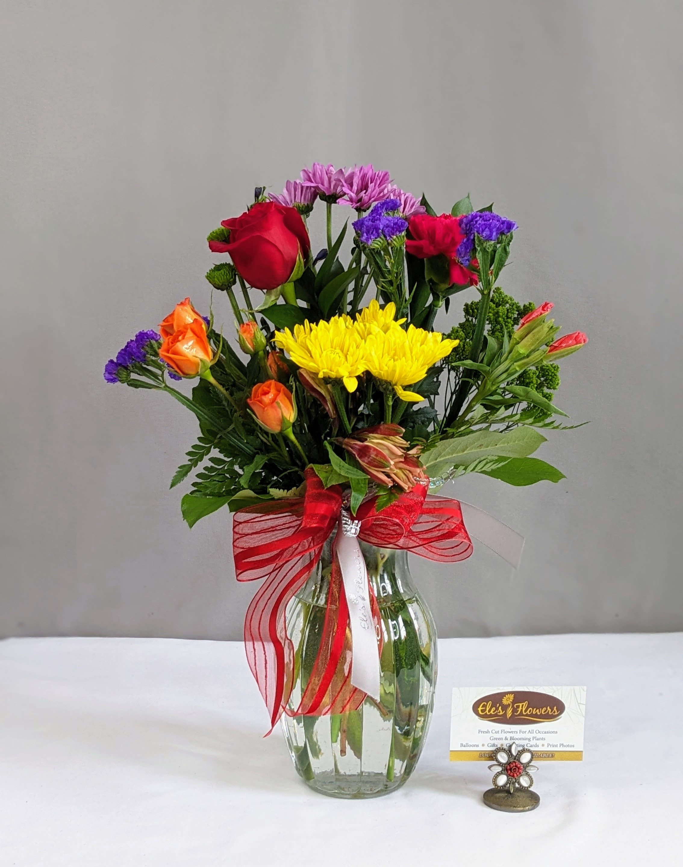 Rainbow Beauty  - Our Rainbow Beauty arrangement incorporates everything we love about color all in one vase. Situated among mixed textured greenery, the vibrant shades of blue, yellow, red, violet and orange blooms are sure to be enjoyed for any occasion.   The designs we create are custom and the blooms and containers will vary. We use the freshest product available to create the perfect floral combination for the recipient! If you have any special requests, please add those in the "special instructions" portion of your order to help us dial in your vision. Otherwise, our skilled designers, Brett &amp; Sara, will take it from here! Please note that the photos are examples only – floral selection will vary.  Standard Size is an excellent desk top size or coffee table Approx. Dimensions: 12”H x 12”W  Deluxe Size is a great centerpiece size (thinking table size) Approx. Dimensions: 19”H x 14”W  Premium Size is a wonderful size for an island, showroom or office Approx. Dimensions: 25”+H x 16”+W