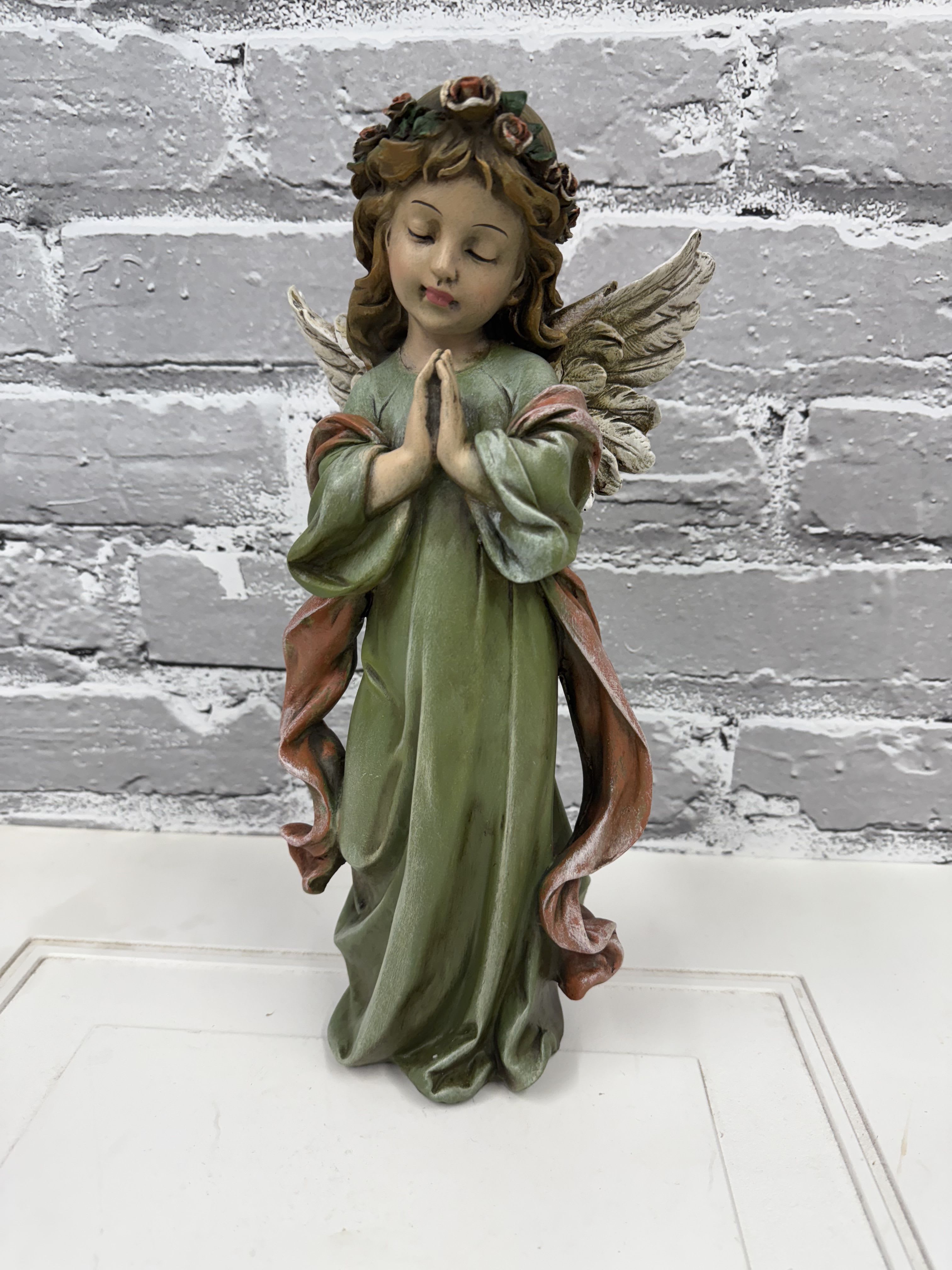 Decorative angel figurine with folded hands and wings
