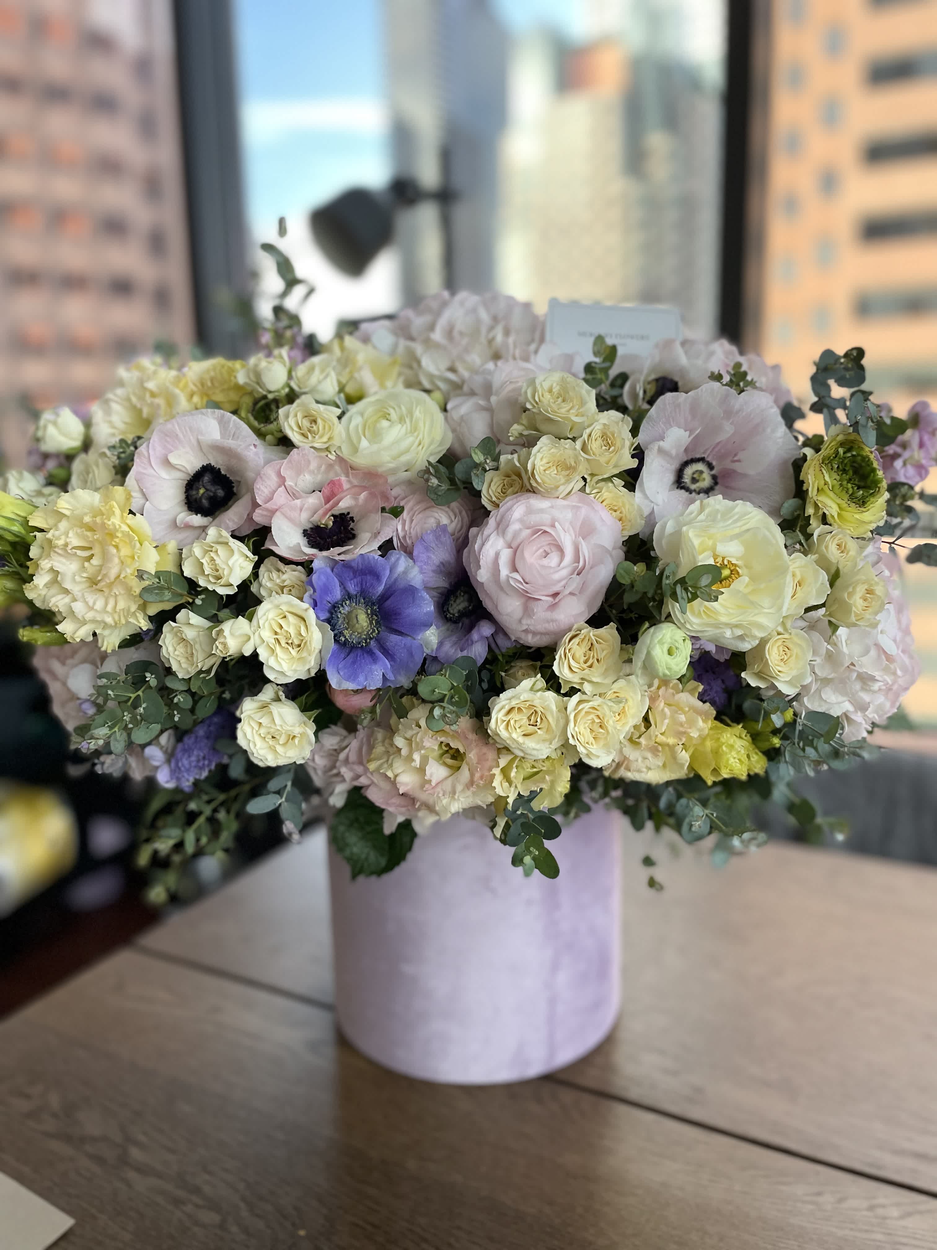 Large pastel bouquet in a pink cylindrical box