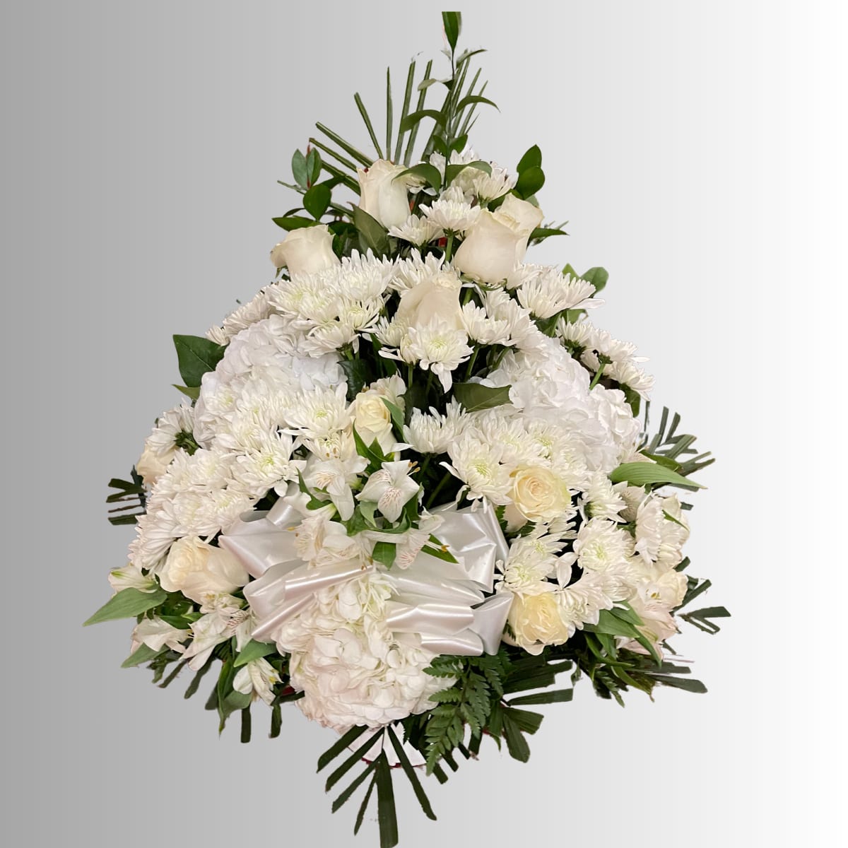 White floral spray with roses, chrysanthemums, and a satin bow