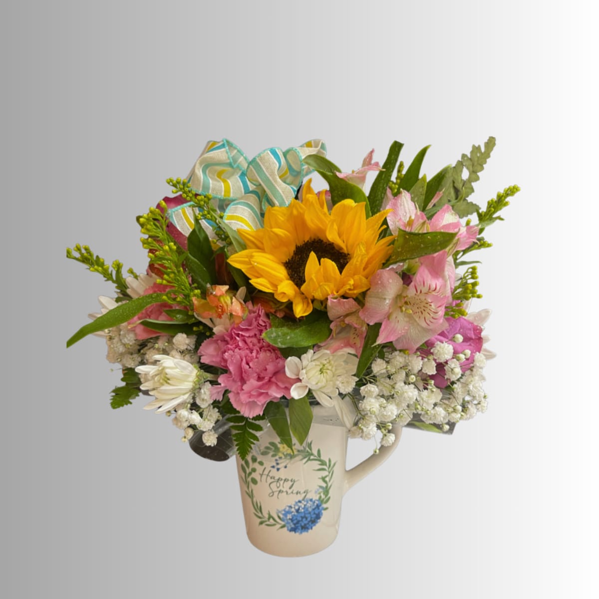 Mixed bouquet with a sunflower in a decorative mug vase