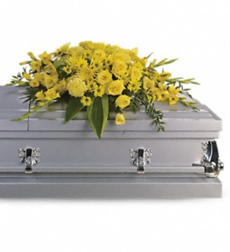 Yellow floral spray on a gray casket
