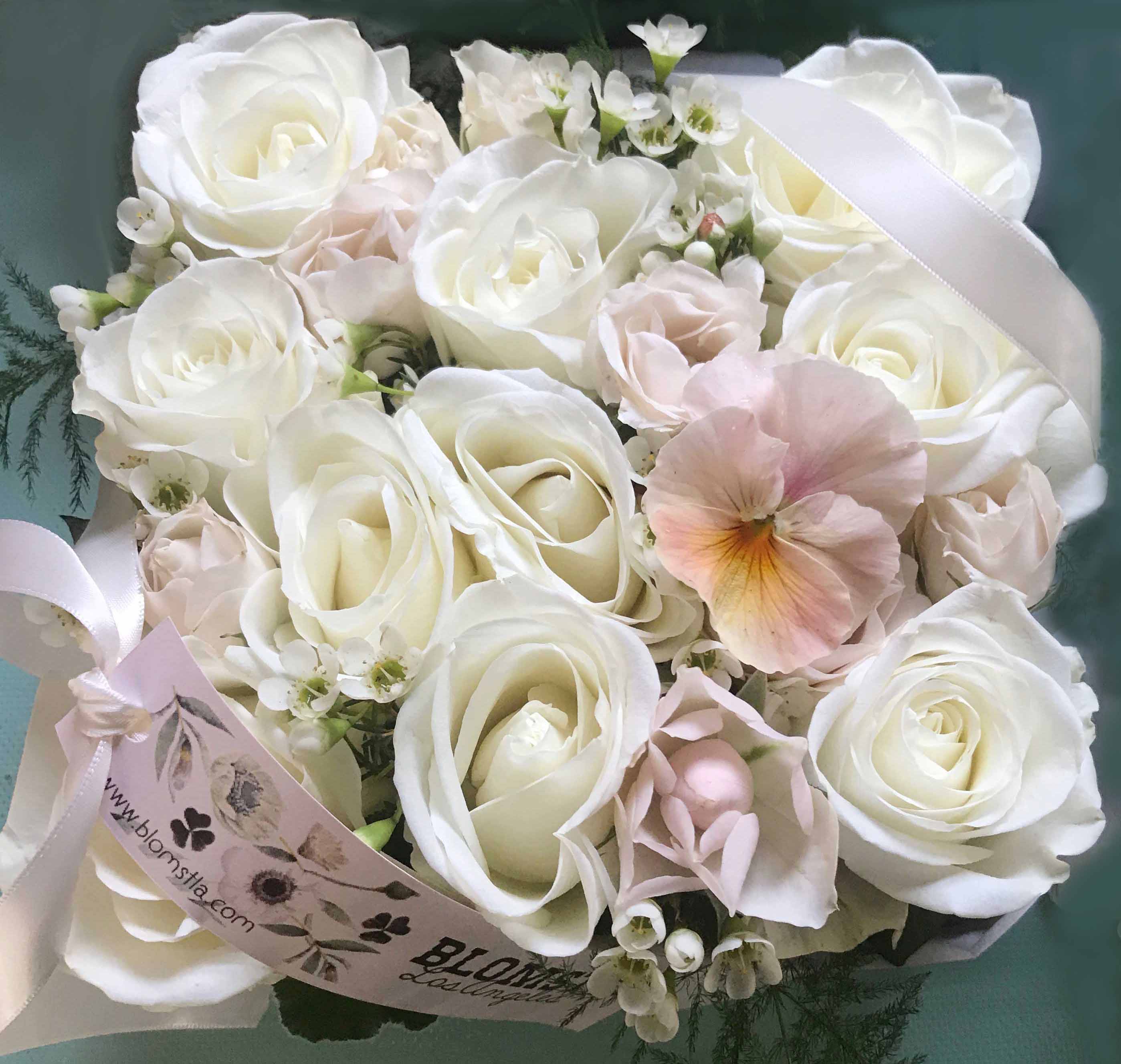 Meadow Flower box - Beautiful blooming flower box full of fresh flowers in a white and pale pastel palette with a light and meadow like feel. Perfect as a gift of romance or just a "Thank you", "I'm sorry" or "Happy Birthday". The rustic gorgeous wooden box is 6" b 6" and 4" tall. The box is wrapped in silk paper and beautiful ribbon with pretty wrapping details and a hand written card.  You can upgrade to Deluxe for more flowers and a larger box (9" by 9"), to premium for more flowers and a larger box, 14" by 14" filled with the most gorgeous flowers.  Blomst LA only uses fresh, high quality flowers, all carefully selected every day to fit your flower order. We offer a personal hand delivery by our own delivery staff and guarantee the flowers will look perfect, when they arrive. We deliver in Glendale, Pasadena, Eagle Rock, Hollywood, Burbank, Beverly Hills and the Pacific Palisades - and everywhere else in Greater Los Angeles.