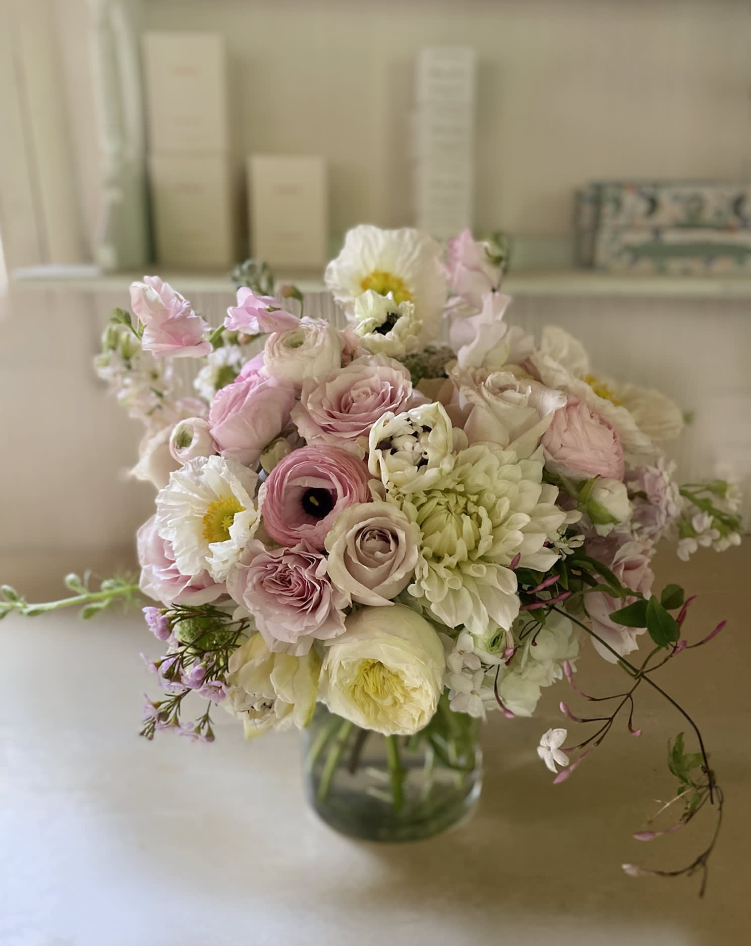 Soft pink and white bouquet in a glass vase