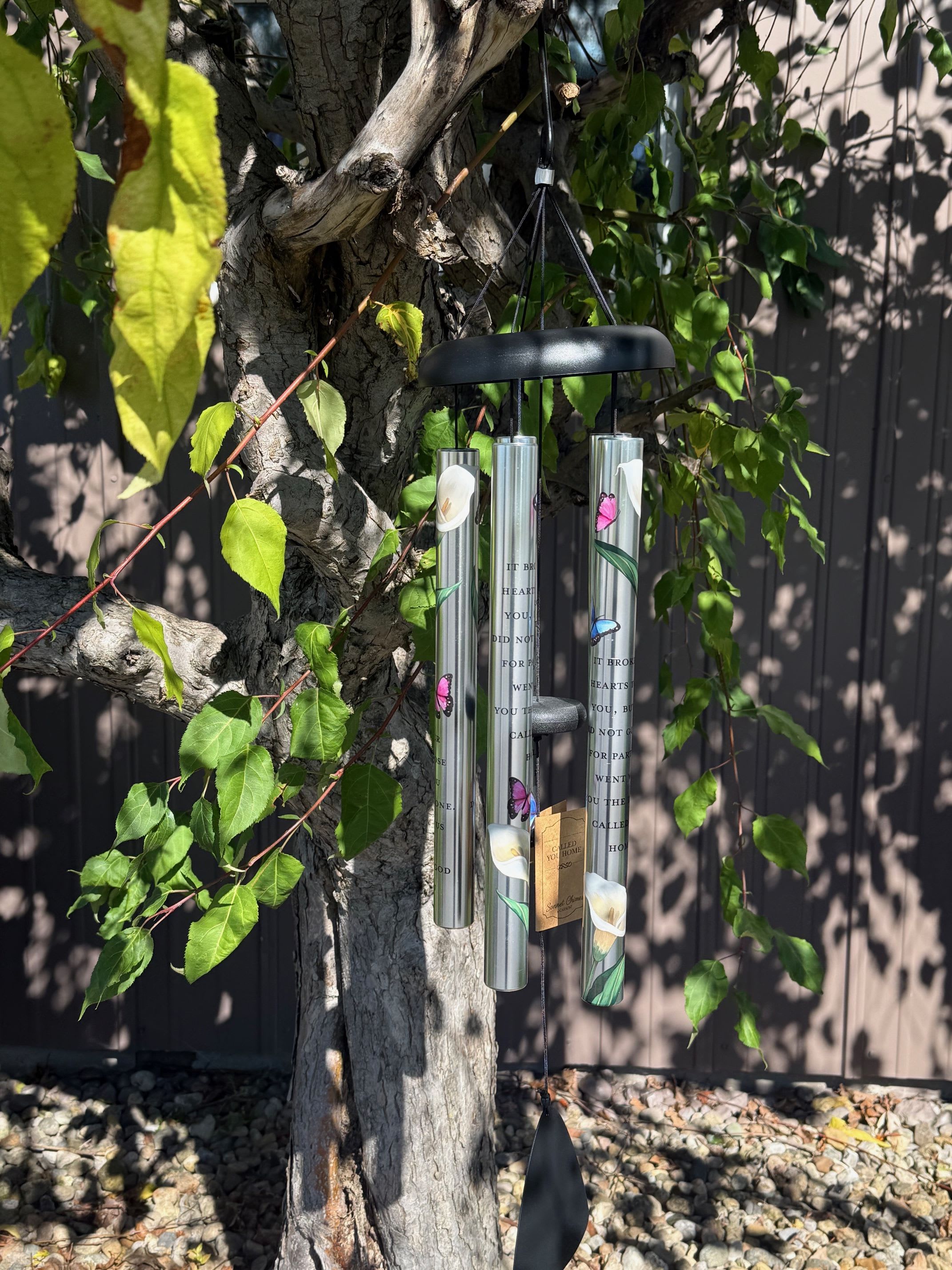 Hanging metal wind chime on a tree branch