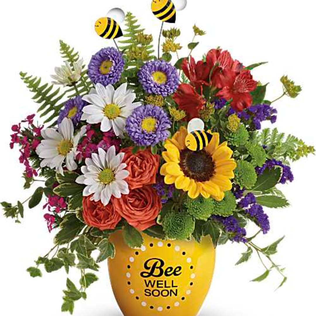 Mixed bouquet in a yellow vase with bee decorations