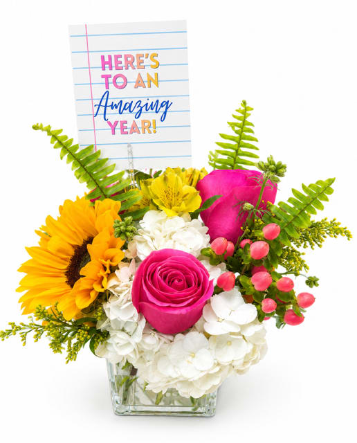The Bright Future Cube  - Celebrate the start of a new school year with The Bright Future Cube, a cheerful floral arrangement designed to brighten any classroom, office, or home. This vibrant design features sunflowers, pink roses, pink hypericum, white hydrangeas, yellow alstroemeria, and lush fern artfully arranged in a modern glass cube vase. Each arrangement includes a keepsake enclosure card that reads, "Here's to an Amazing Year!" making it a thoughtful gift for students, teachers, principals, and school staff.  Whether you're welcoming a new school year, thanking a favorite teacher, or sending encouragement for a fresh start, The Bright Future Cube is a meaningful way to celebrate new beginnings. We proudly offer local flower delivery to Smyrna, Mableton, Marietta, Powder Springs, and Austell, making it easy to send a bright and memorable gift throughout the community.