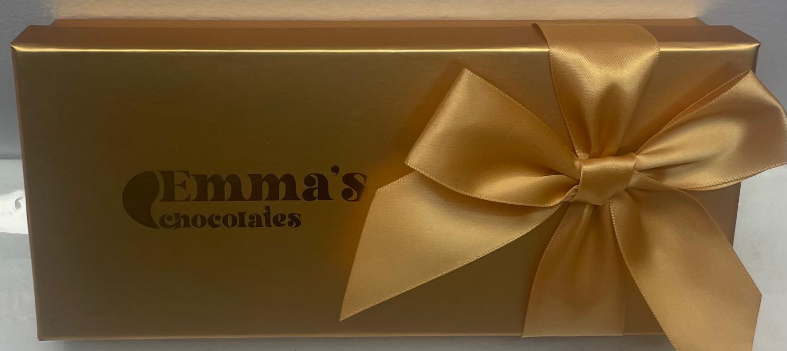 Gold gift box with a satin bow and Emma's Chocolates logo