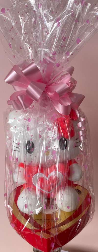 Gift basket with a Hello Kitty plush, wrapped in clear cellophane and pink ribbon