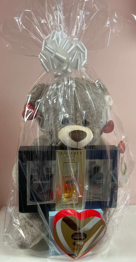 Gift basket with a teddy bear, cologne set, and heart-shaped chocolate box