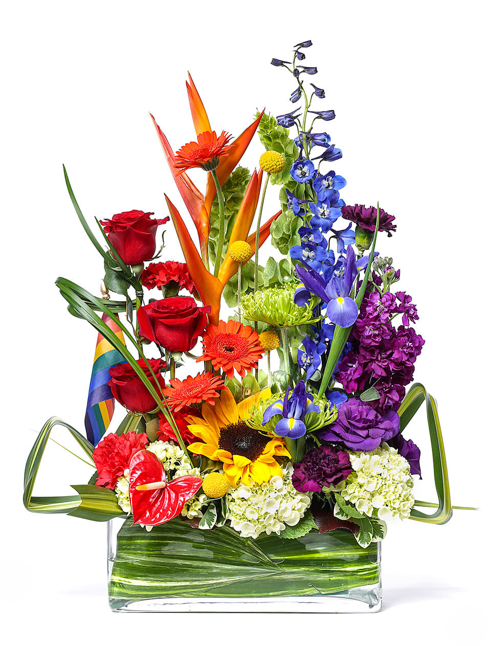 Colorful mixed bouquet in a clear rectangular vase with rainbow ribbon