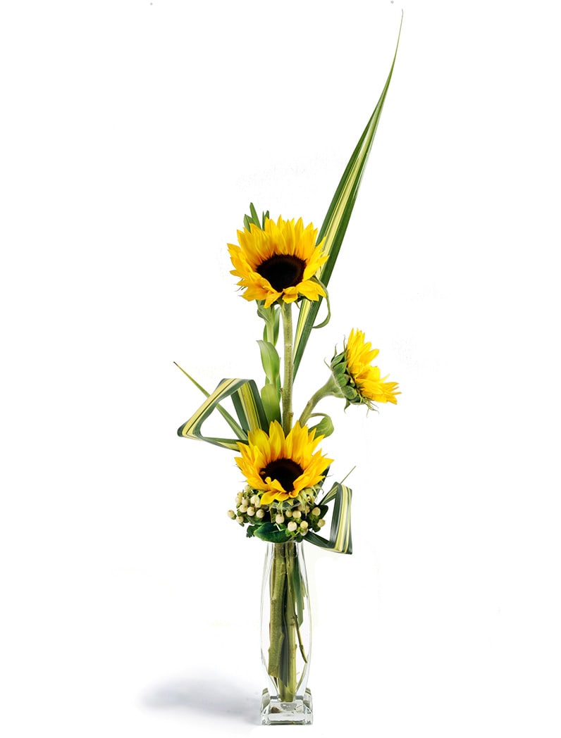 Tall sunflower arrangement in a clear glass vase