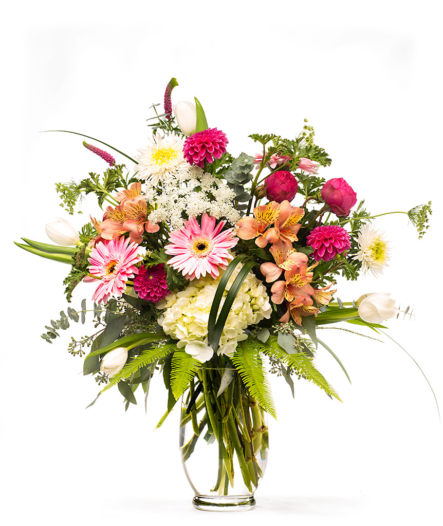 Mixed pink and white bouquet in a clear glass vase