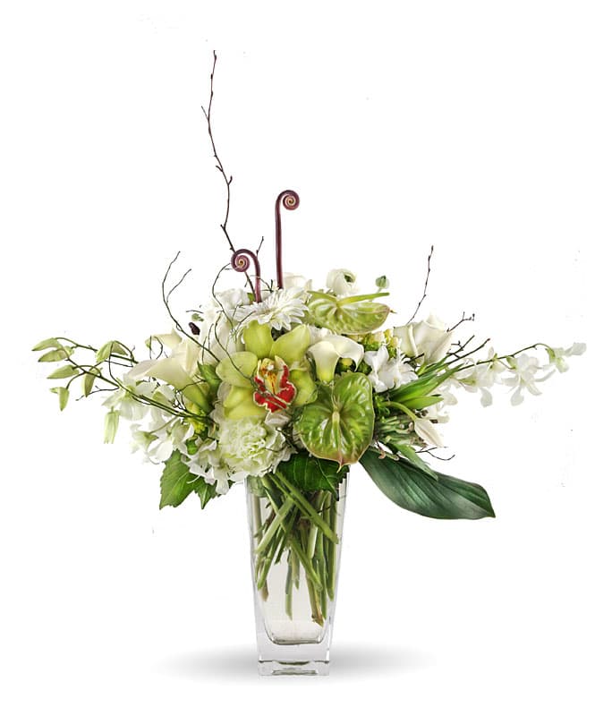 White and green floral arrangement in a clear glass vase