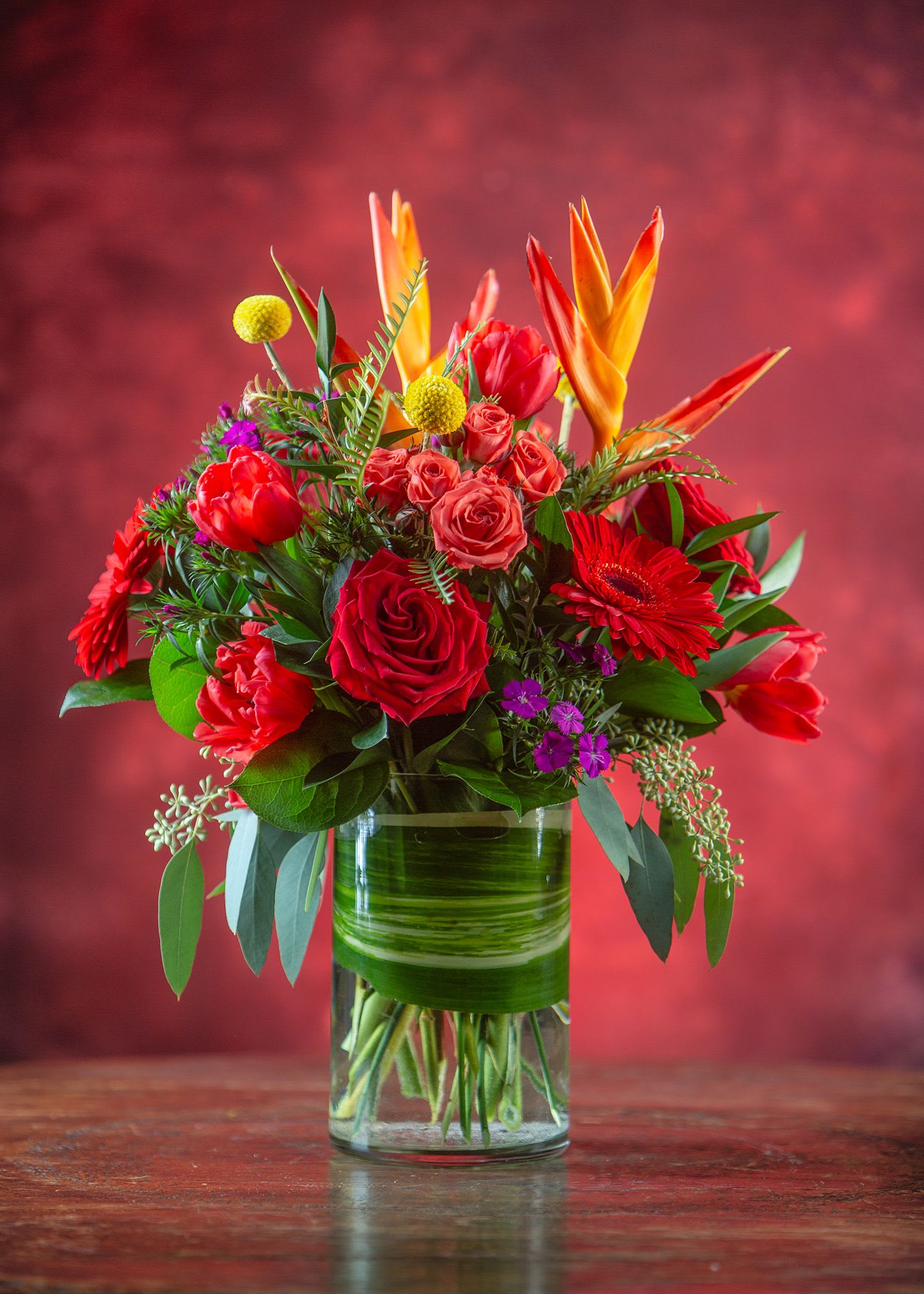Bouquet of red and orange flowers in a glass vase