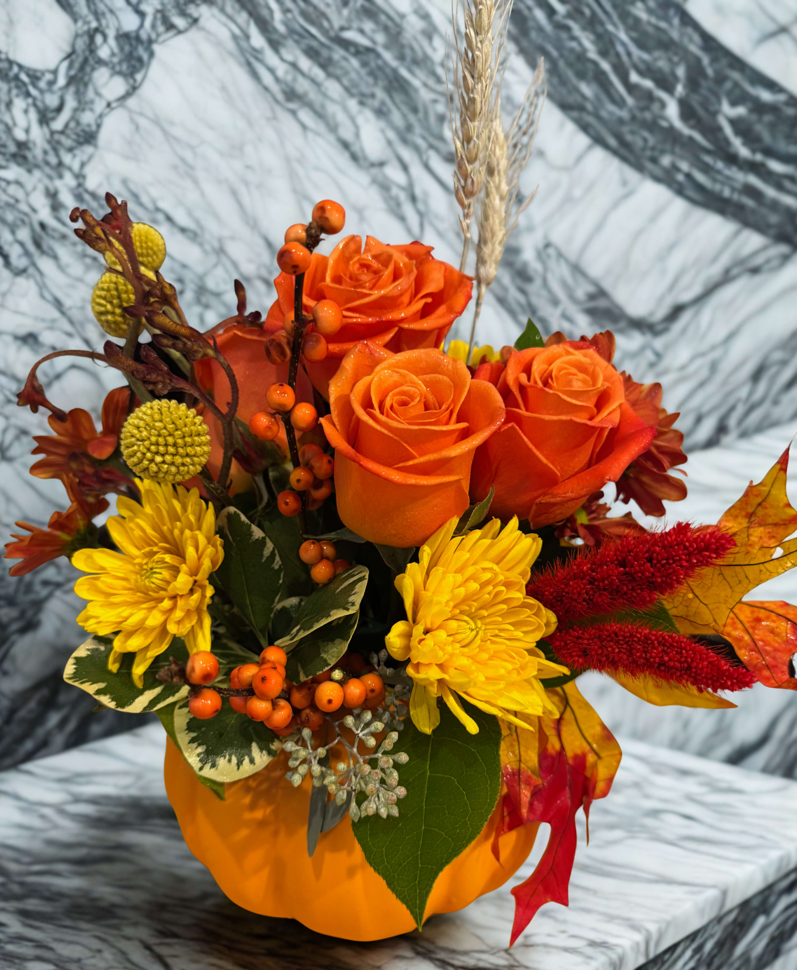 Our Version of the FTD Golden Gourd Pumpkin Bouquet - Celebrate the season with a charming blend of autumn’s most beloved blooms. This gorgeous bouquet features an assortment of fresh, in-season stems—roses, carnations, fall leaves, wheat sprigs, chrysanthemums, berries, and more—artfully arranged to bring warmth and happiness to any space. Designed in a beautifully crafted ceramic pumpkin vase, this arrangement makes the perfect festive centerpiece or cheerful gift. 