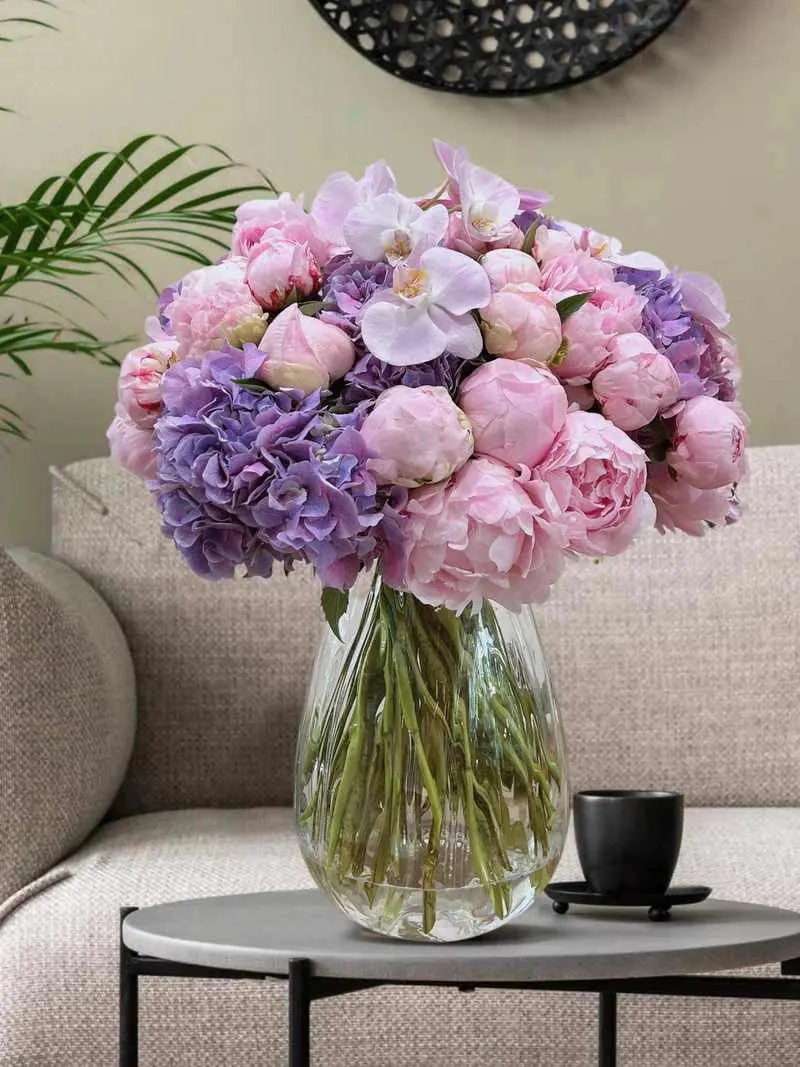 A captivating luxury bouquet - A captivating luxury bouquet in a vase showcasing pink peonies, hydrangeas, and orchids. This arrangement evokes the magical hues of a cotton candy sky with its gorgeous shades. "Fairy Floss" is an exceptionally special bouquet for someone truly dear, guaranteed to evoke delight and admiration with its graceful allure.