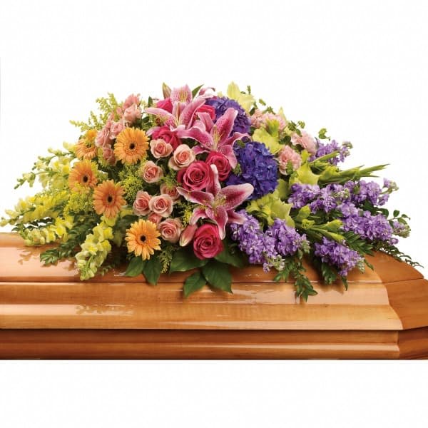 Colorful floral spray on a wooden casket