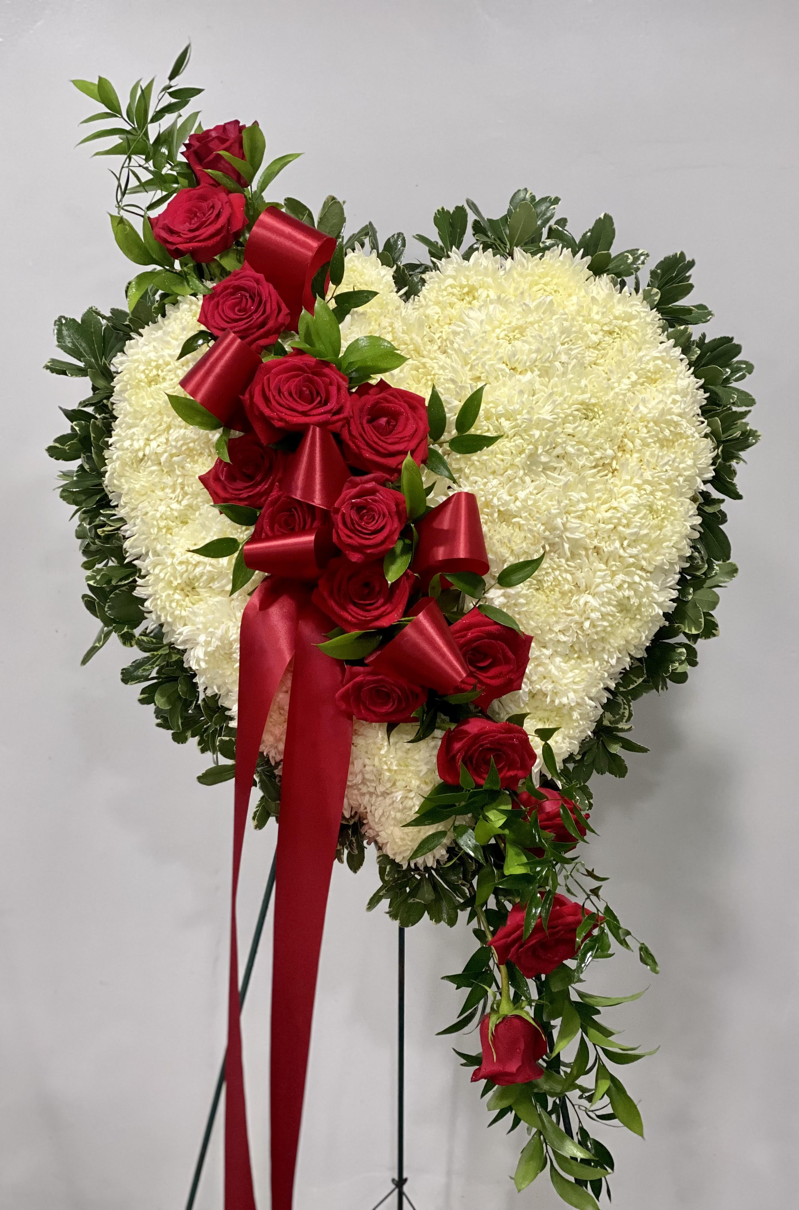 Heart-shaped floral spray with red roses and white chrysanthemums
