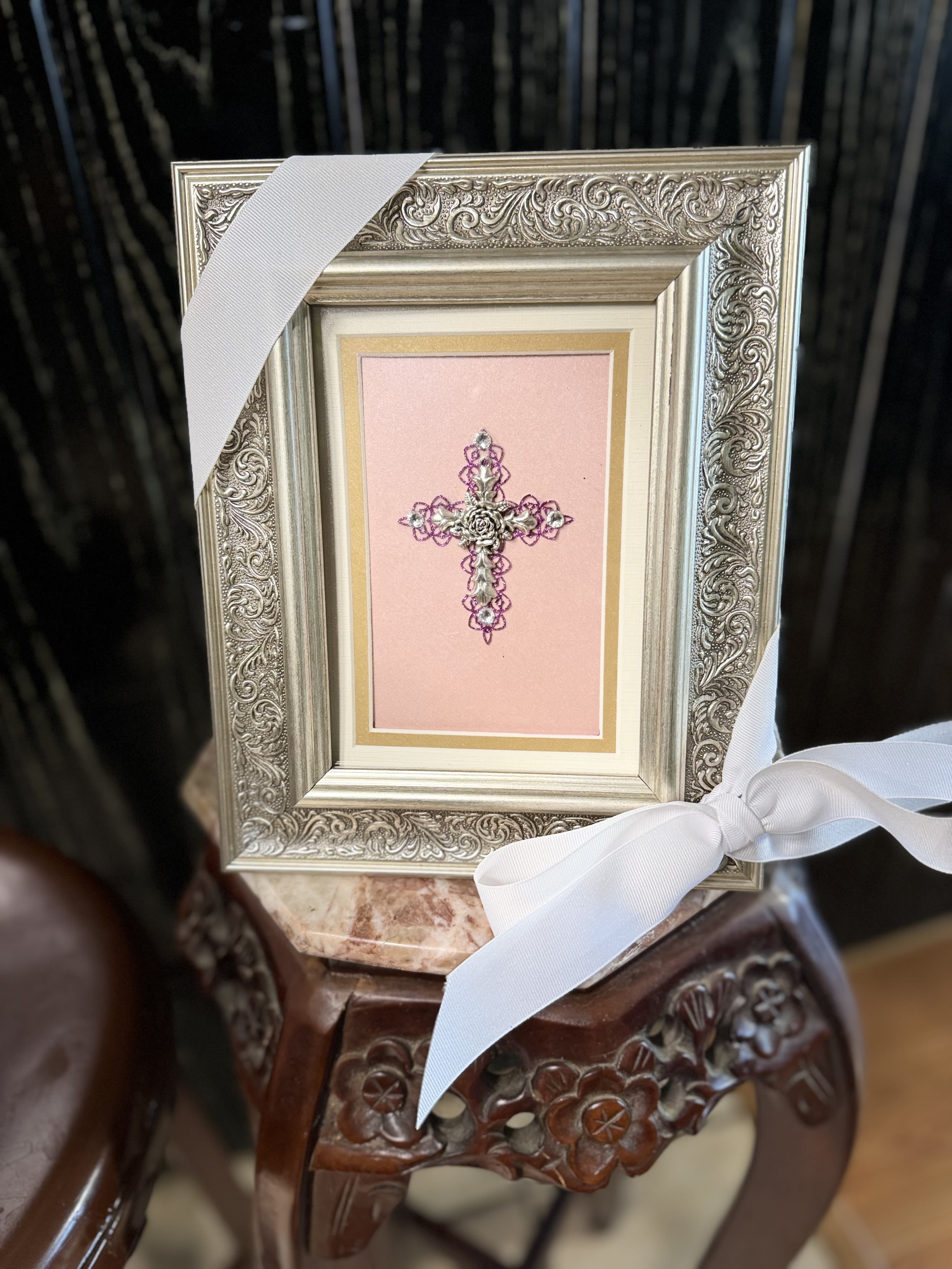 Framed pink cross ornament with white ribbon bow