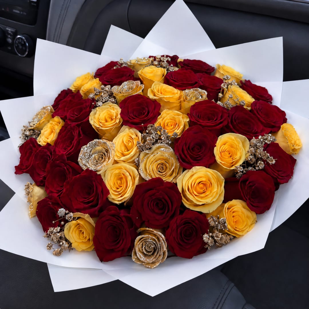 Bouquet of red and yellow roses wrapped in white paper