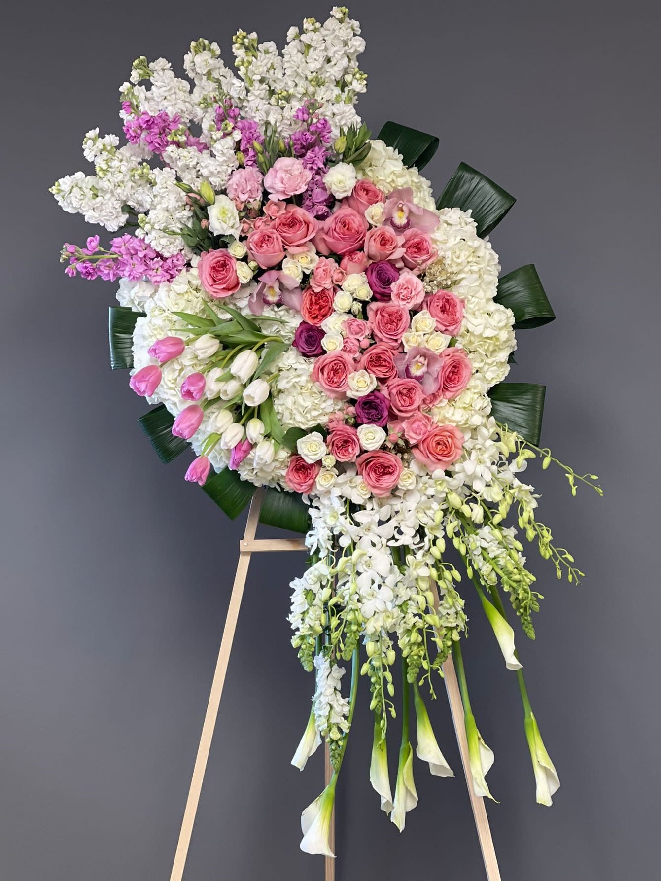 Large pink and white floral standing spray on an easel